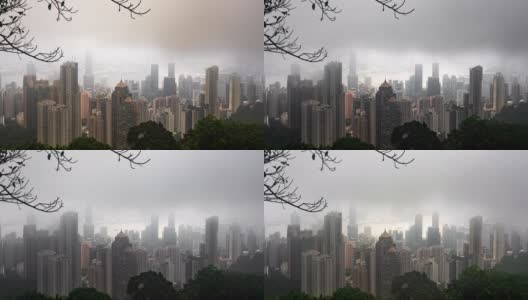 4K时间跨度的摩天大楼和城市景观在多云大雾的早晨日出从维多利亚山顶海港，香港。在中国香港的摩天大楼建筑工业上空移动云的高角度鸟瞰图。高清在线视频素材下载