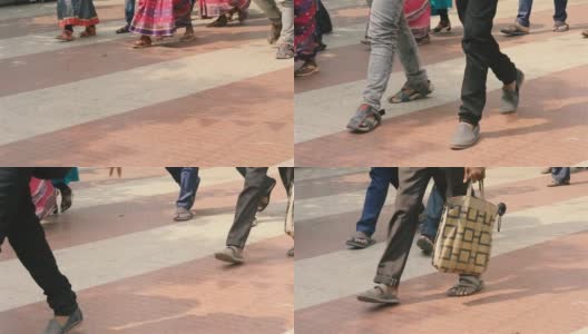 城市人走在街上。人群在路上行走的录像。低角度的观点。脚和腿只接近身体部位的四分之三。高清在线视频素材下载