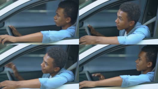紧张的非洲裔美国少年在车里被困在交通堵塞，开车高清在线视频素材下载