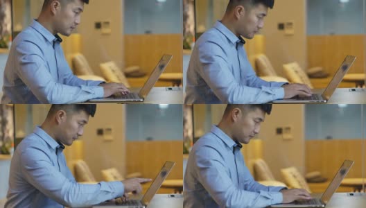 年轻的亚洲商人用笔记本电脑工作高清在线视频素材下载