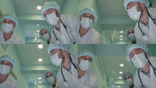 一组外科医生在去手术室的路上低头看着病人高清在线视频素材下载