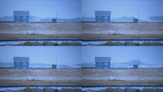 冰岛哈夫尼尔，小房子前巨浪，汹涌的海风暴潮高清在线视频素材下载