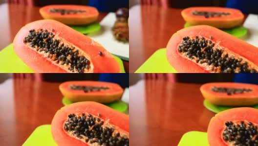 餐桌上有异国情调的热带水果。泰国的水果。番木瓜，切成两半。特写镜头高清在线视频素材下载