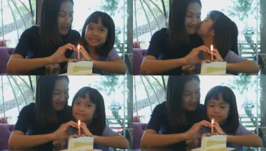 女孩和妈妈一起享用着生日蛋糕，手打心牌高清在线视频素材下载