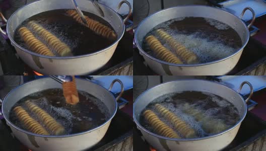 泰国街头小吃，一名泰国男子在夜市煎土豆片高清在线视频素材下载