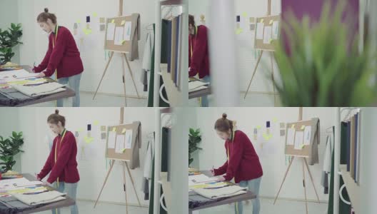 年轻的亚洲女性时装设计师在工作室工作时，用铅笔和看纸画画。高清在线视频素材下载