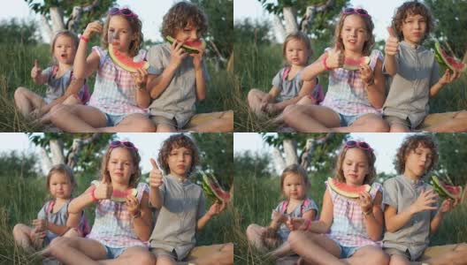 孩子们喜欢吃西瓜，并竖起大拇指。类。健康食品，暑假高清在线视频素材下载