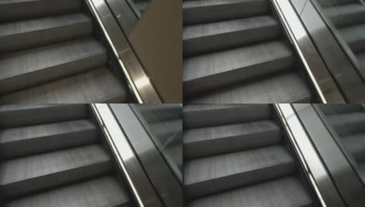 看着自动扶梯上的楼梯高清在线视频素材下载