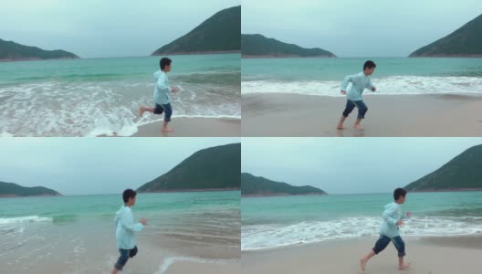 顽皮的男孩在海滩上开始和奔跑高清在线视频素材下载