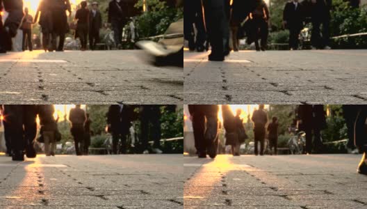 人们走在光晕击中镜头。低角度拍摄行走在城市生活中的人们高清在线视频素材下载