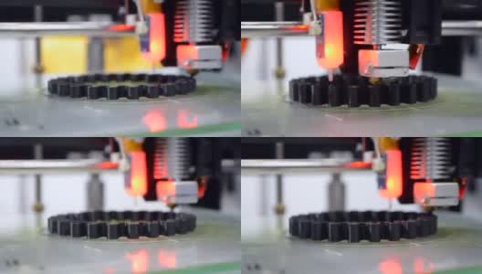 3d打印机打印黑色物体模型橙色特写。高清在线视频素材下载