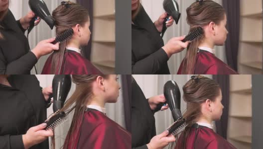 一名美发师用吹风机为一名年轻女子吹干长长的直发高清在线视频素材下载