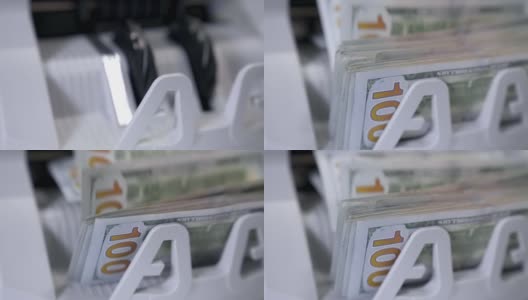 纸币现金计算。电子点钞机正在点钞。详细查看柜台机器上的百元钞票。高清在线视频素材下载