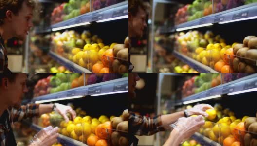 超市里，店员戴着透明手套，用各种各样的有机食品填满柠檬货架。超市店员正在把水果放在商店的货架上高清在线视频素材下载