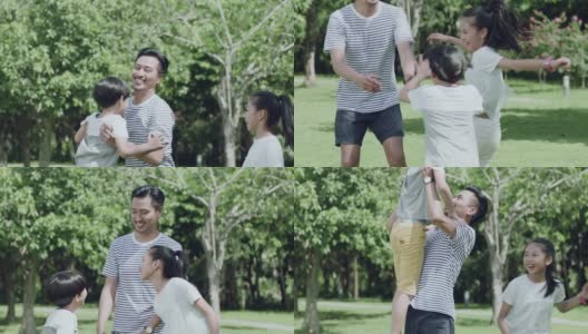 一位亚裔父亲在公园里和孩子们玩的时候把他的儿子抱起来高清在线视频素材下载