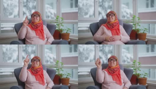 穆斯林妇女戴着智能眼镜听音乐或播客高清在线视频素材下载