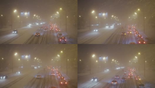 暴风雪期间公路上的汽车高清在线视频素材下载