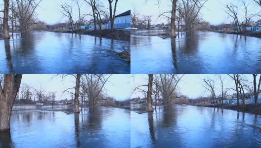 春雪融水时镇上河水泛滥。涌入城市。自然灾害。城市里的大水高清在线视频素材下载