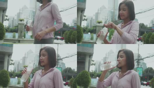 亚洲妇女喝水。人们早上慢跑锻炼高清在线视频素材下载