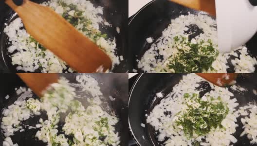 在平底锅中放入切碎的洋葱，厨师加入大蒜和香草。高清在线视频素材下载
