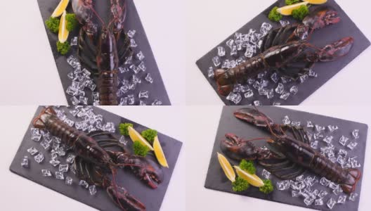 新鲜的龙虾在黑色花岗岩石头上旋转转盘。高清在线视频素材下载