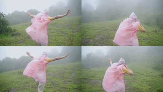 慢镜头后视图的年轻亚洲女子徒步旅行者在雨中与强风吹在山上的小山。美丽的女孩感受自由享受冒险旅行与美丽的自然旅行。高清在线视频素材下载