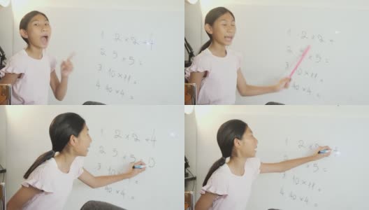 快乐的亚洲女孩教数学科目为她的妹妹在白板上在家上学，呆在家里的概念。高清在线视频素材下载
