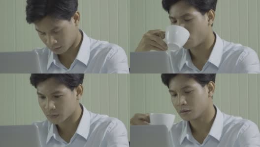 年轻的商人在办公室工作。他一边工作一边喝咖啡。高清在线视频素材下载