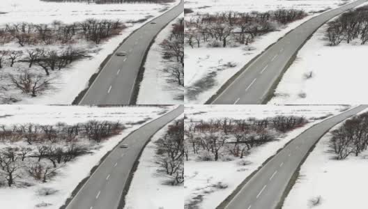 冬天的风景。鸟瞰图的道路在冬季与车辆。冰冻的冬天森林高清在线视频素材下载