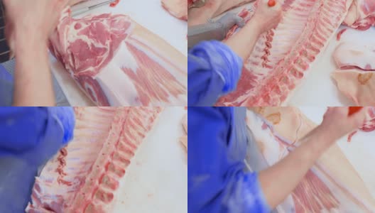 屠夫在切割车间的肉类加工厂切猪肉高清在线视频素材下载