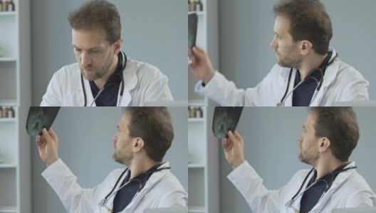 男医生在医院看鼻骨x光片，填写文件高清在线视频素材下载