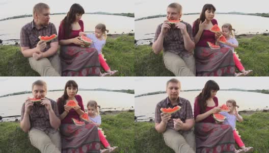 在一个夏日，一家人在池塘边野餐，一起吃西瓜高清在线视频素材下载
