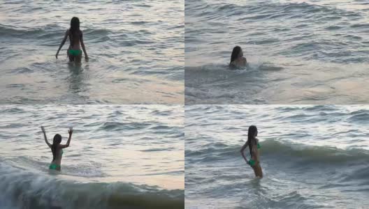 穿着比基尼的女人在海滩上玩水后视图，快乐的女性游客在暑假高清在线视频素材下载