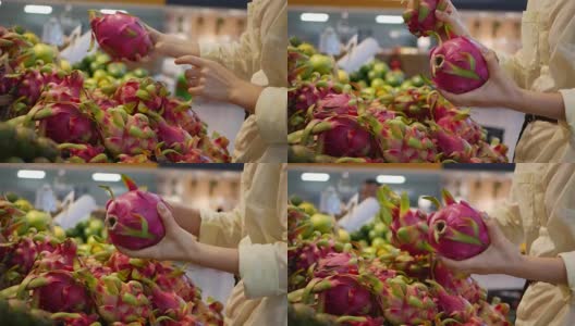 女人的手在超市挑选新鲜的生火龙果高清在线视频素材下载