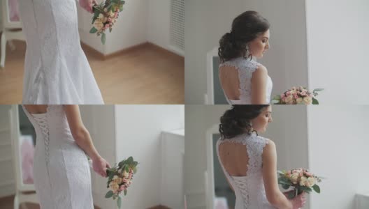 漂亮的新娘，捧着花束站在镜子旁边高清在线视频素材下载
