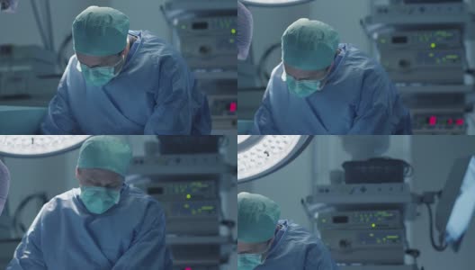 现代手术室中护士擦拭医生前额汗水高清在线视频素材下载