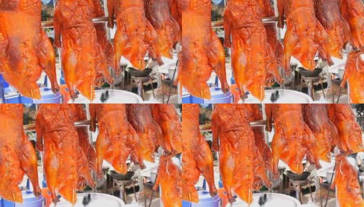 泰国和亚洲的街头小吃。柜台上的红色北京烤鸭。大街上的异国菜肴高清在线视频素材下载