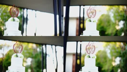 MS Dolly右相机优雅的婚礼蛋糕装饰鲜花在花园里。高清在线视频素材下载