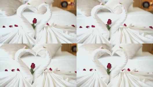 卧室有两条装饰有花的天鹅毛巾。高清在线视频素材下载