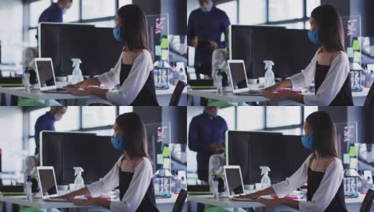 亚洲妇女戴着口罩在现代办公室用纸巾清洁她的笔记本电脑高清在线视频素材下载
