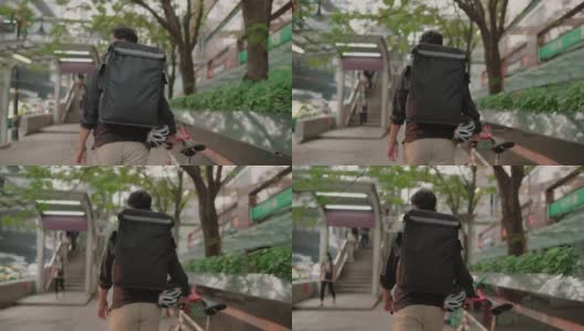 一个骑车送快递的人正在穿过城市高清在线视频素材下载