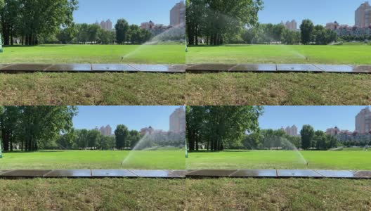 浇水高尔夫球场。自动洒水器浇灌草坪。高清在线视频素材下载