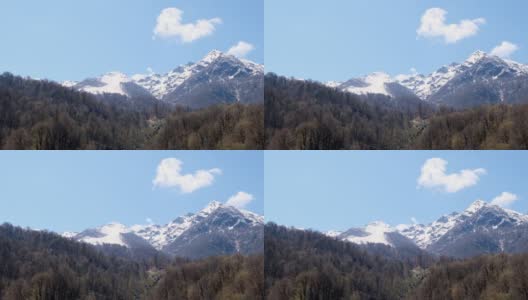 在俄罗斯索契，阳光明媚的一天，白雪皑皑的山脉和蓝天白云的美丽风景。著名的滑雪胜地高清在线视频素材下载