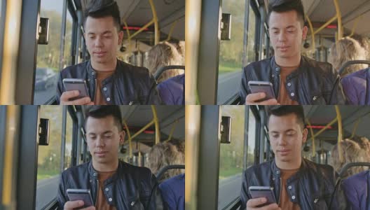 一个年轻人在公交车上用智能手机高清在线视频素材下载