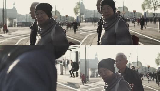 一对亚裔老年夫妇在阿姆斯特丹等电车。退休后自己环游世界高清在线视频素材下载