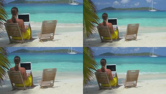一名女子在加勒比海海滩上用笔记本电脑工作的视频高清在线视频素材下载