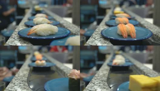 寿司和生鱼片。寿司和生鱼片在传送带上滚动。日本传统的生活方式。高清在线视频素材下载