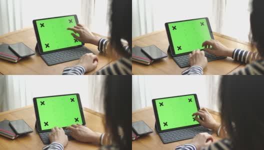 Young woman using digital tablet with a green screen高清在线视频素材下载