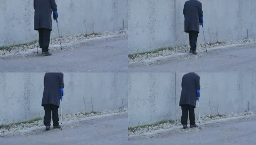老年残疾人背景。这位老人拄着拐杖走在公共场合。高清在线视频素材下载