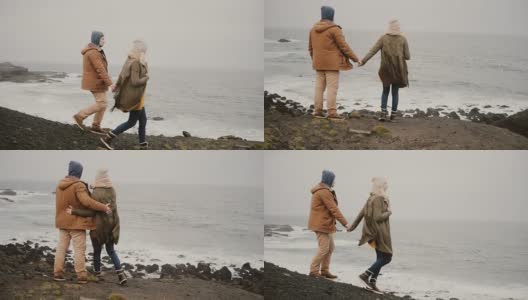 一对年轻的旅行情侣在海边散步。有魅力的男女在水边接吻高清在线视频素材下载